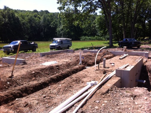 Laying the plumbing pipes underneath where the slab will be poured